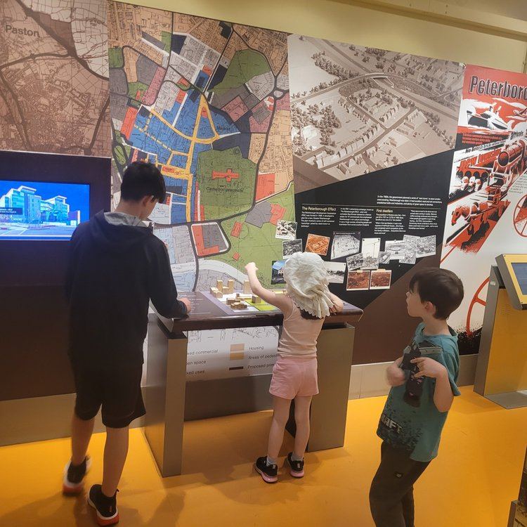 Children exploring an interactive museum exhibit about local history